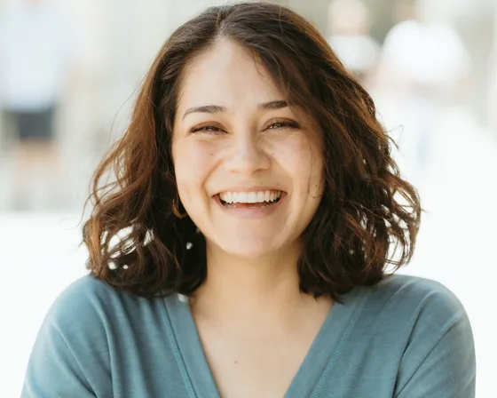 Woman laughing with a natural smile