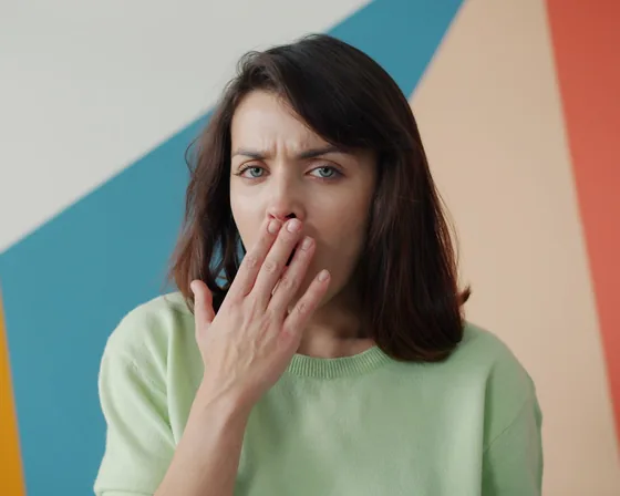 Woman covering her mouth with her hand