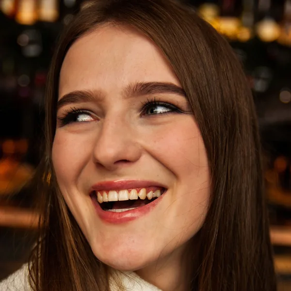 Young woman laughing with a natural smile